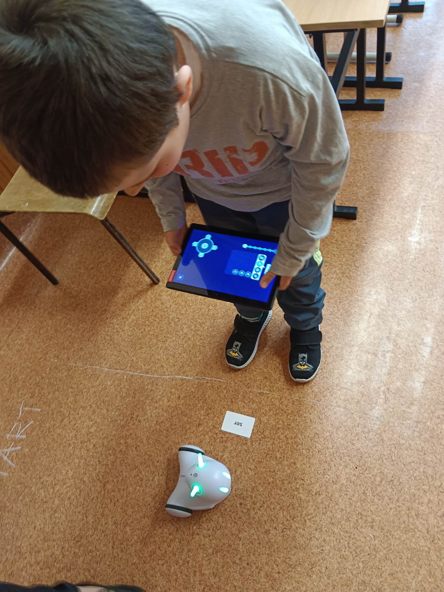 Chłopiec steruje robotem Photon za pomocą tabletu.