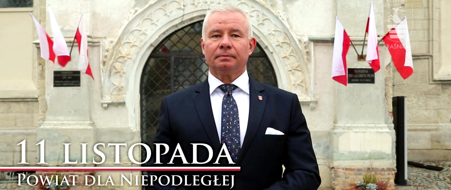 Grafika przedstawia Starostę Kraśnickiego Andrzeja Rollę na tle kościoła Wniebowzięcia Najświętszej Maryi Panny w Kraśniku.