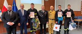 Spotkanie nagrodzonych w kategorii III w Starostwie. Na zdjęciu nagrodzona trójka młodzieży z upominkami oraz dyplomem, przedstawiciele OSP oraz Starosta Powiatu Nowotarskiego i Burmistrz Nowego Targu