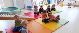 Dzieci pozują do zdjęcia w przedszkolnej sali gimnastycznej