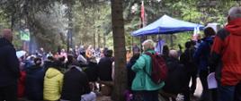  Jubileuszowa Majówka - uczestnicy majówki siedzą na drewnianych ławkach