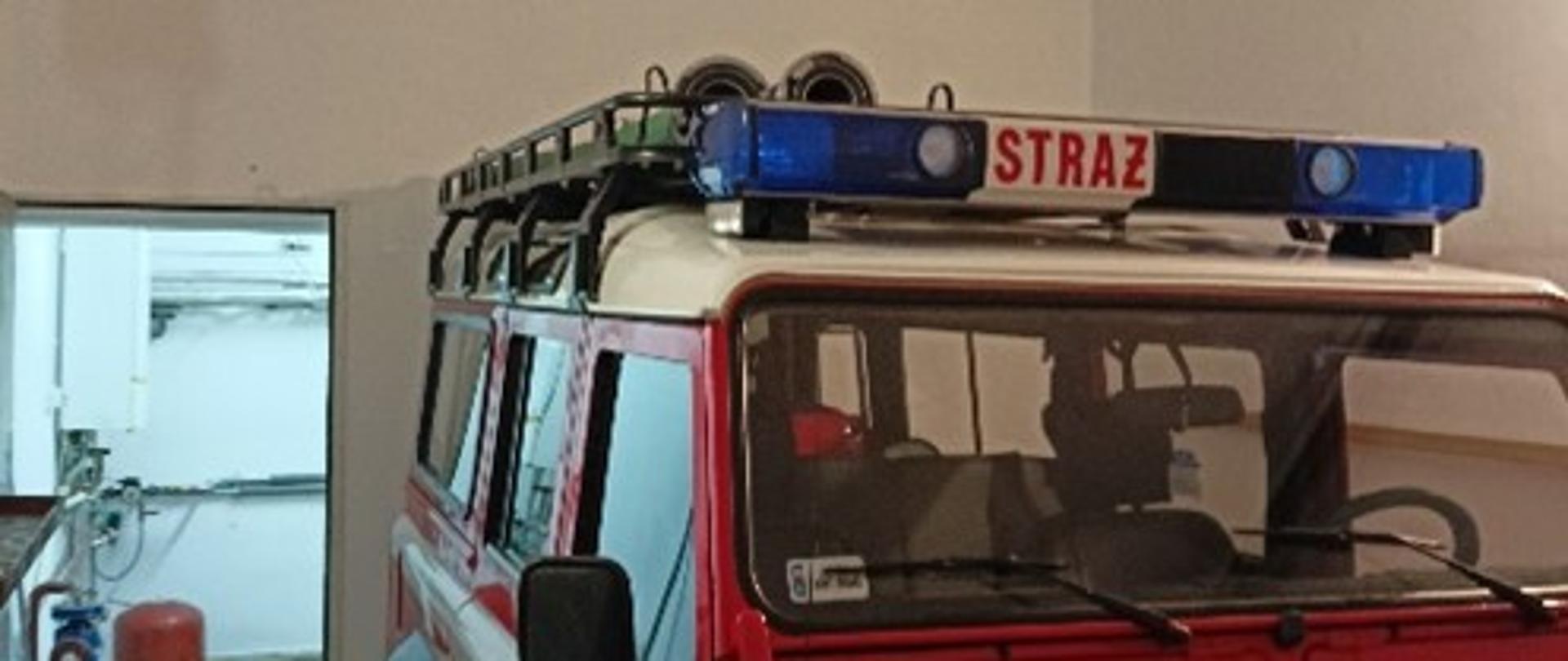 Samochód strażacki stojący w garażu w remizie OSP