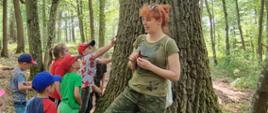 Zajęcia edukacyjne w Nadleśnictwie Browsk - dzieci w lesie słuchają prelekcji