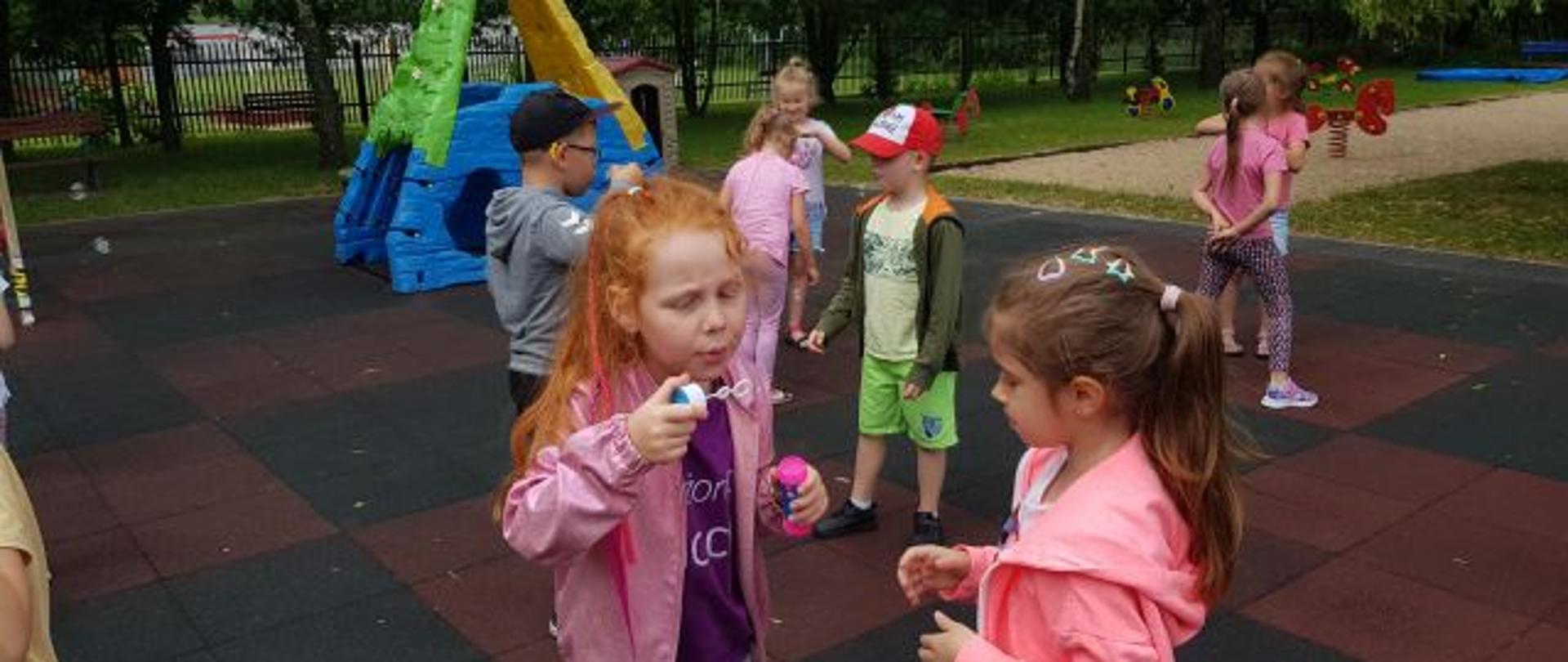 Rekreacja na placu zabaw - dzieci puszczają bańki