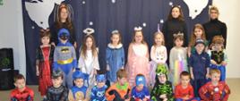 Dzieci w strojach karnawałowych pozują do zdjęcia