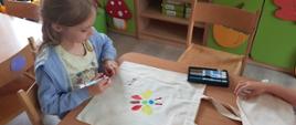 Dzieci w trakcie zabawy w przedszkolu - malowanie toreb