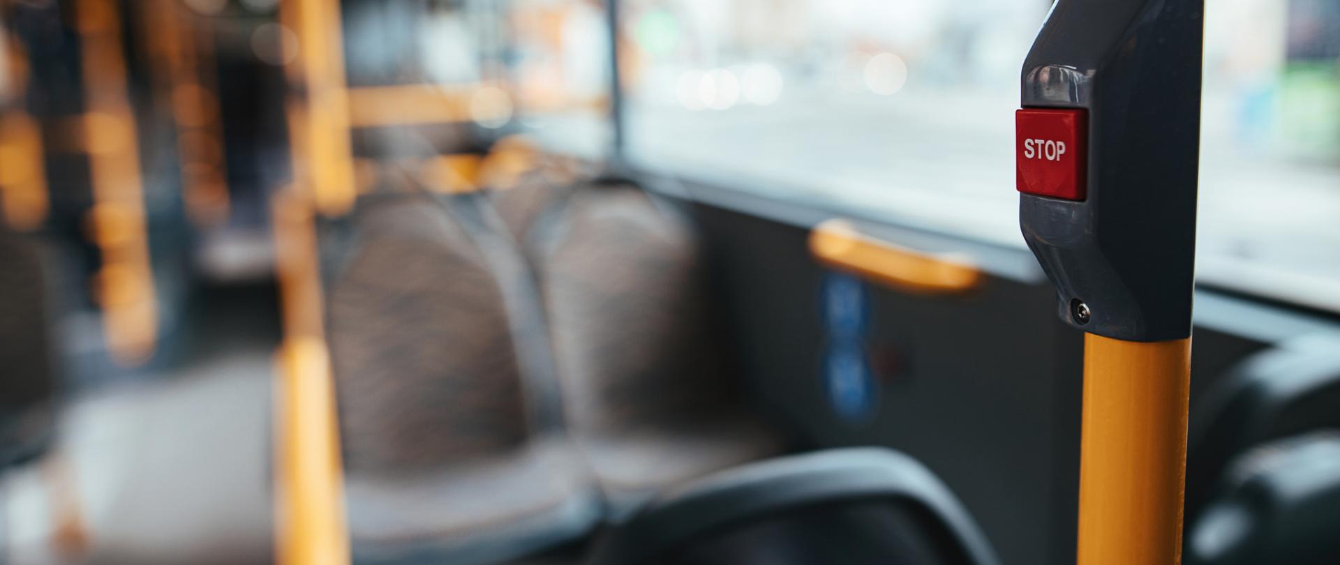 Close-up of handle in empty public bus during COVID-19 pandemic.