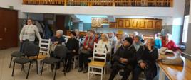 Grupa Seniorów uczestnicząca w spotkaniu, siedzi na krzesłach w Domu Parafialnym w Rabie Wyżnej.